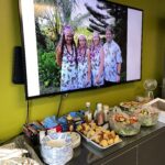 With photos of Mike Trump and his family displayed on a large screen overhead, EnviroScience employees filled a table of tasty foods to complement the chili-tasting ceremony.