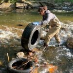 Senior Environmental Scientist Yakuta Bhagat Removing an Old Tire from the Little Cuyahoga River