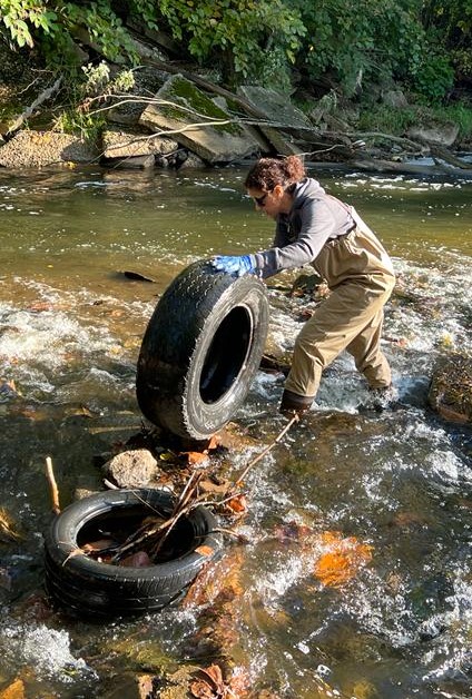 Senior Environmental Scientist Yakuta Bhagat Removing an Old Tire from the Little Cuyahoga River