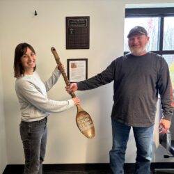Tim Willaman Passes the Coveted 1st Place Wooden Spoon to 2024 Mike Trump Chili Cookoff Winner Alison Frohn