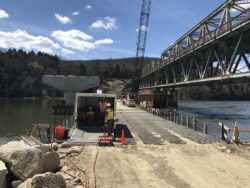 Bridge construction site with crew and heavy equipment, illustrating federal infrastructure projects undergoing NEPA environmental review.