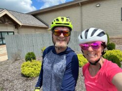 nviroScience staff Brad Bartelme and Emmalisa Kennedy, Wetlands Operations Manager, smiling in bike gear during a sunny team ride for Bike Month 2025.