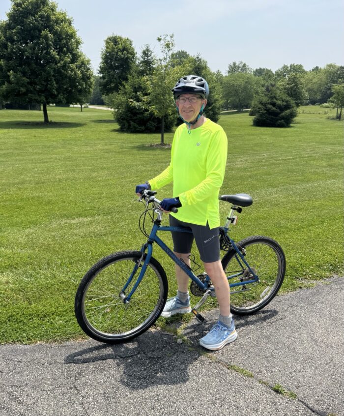 David Altfater, Senior Scientist at EnviroScience, standing with his bicycle in a park after logging 300.1 miles during National Bike Month 2025.