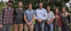 EnviroScience Hendersonville, NC staff team group photo outdoors, featuring biologists, environmental scientists, and project managers standing in front of trees during summer field season.