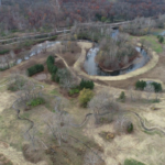 Aerial view of Riverwood Golf Course restoration in Akron, Ohio, showing reconnected Cuyahoga River meanders, newly constructed streams, and restored floodplain wetlands.