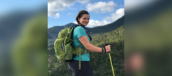Laura Muzal, EnviroScience Marine Senior Project Manager and Technical Writer, hiking with field gear in a mountainous landscape.